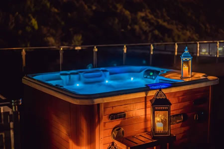 licensed electrician installing a gfci spa disconnect beside a backyard hot tub in Boerne, TX