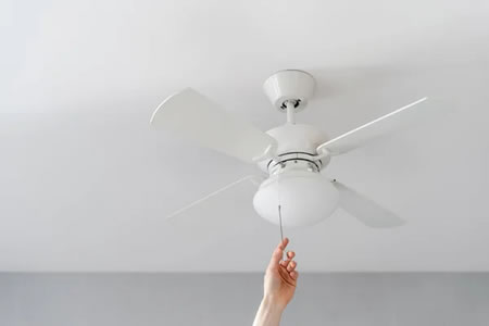 Electrician replacing a fan-rated ceiling box in a San Antonio attic